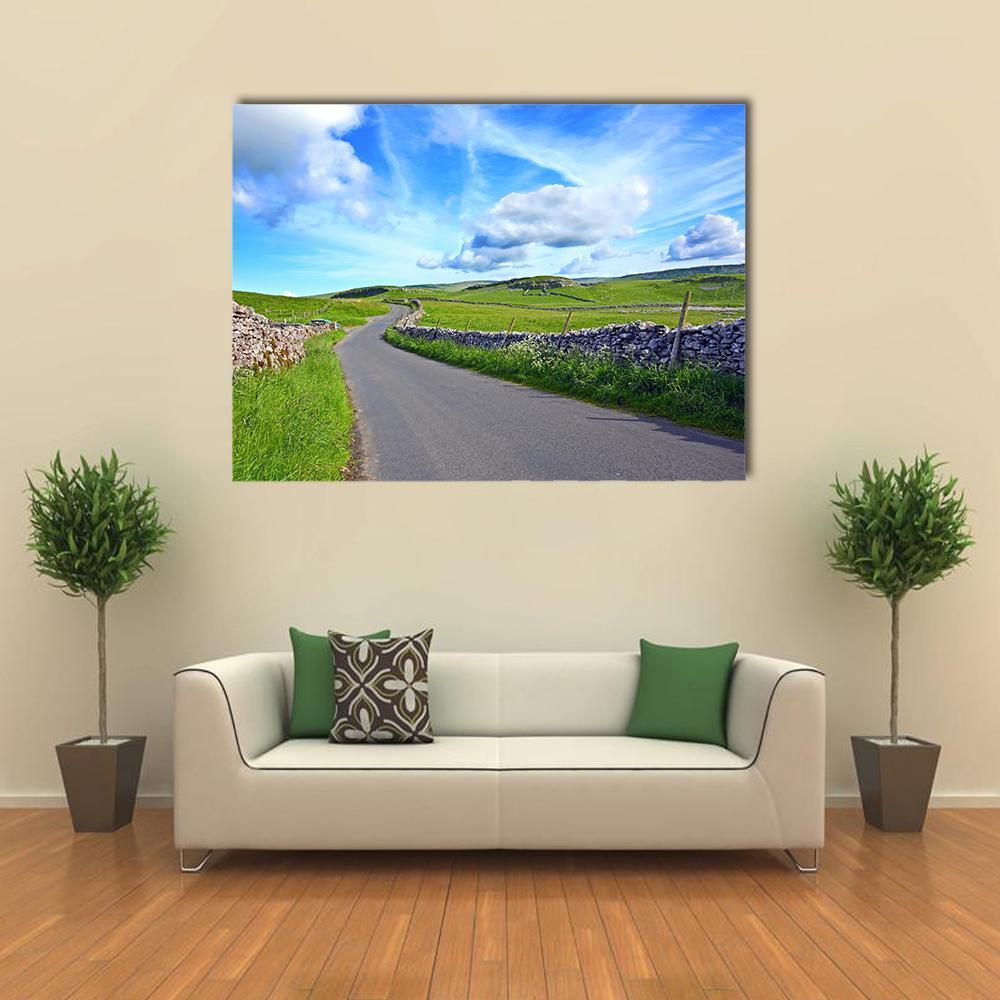 Winding Country Road with Dry Stone Walls Canvas Wall Art in gray, green and blue, single panel hung on a wall