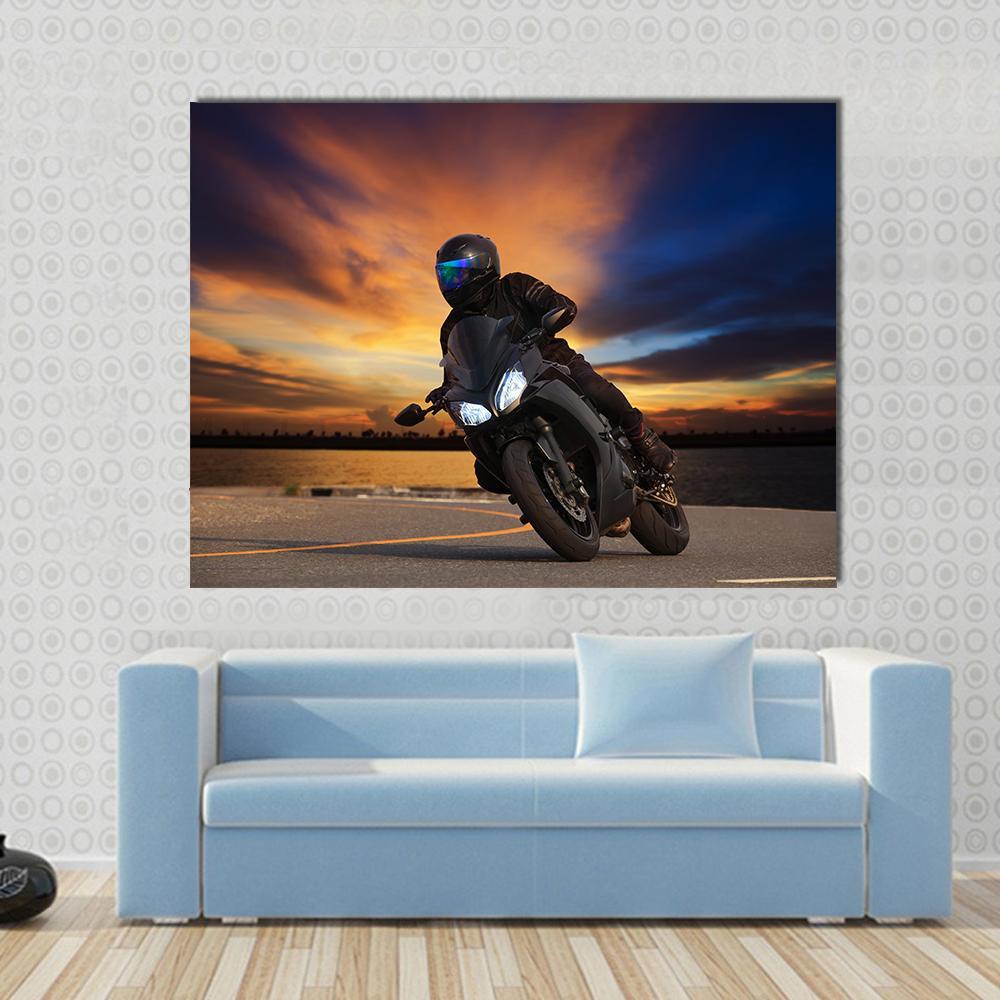 Young Bike Rider Canvas Wall Art in black, orange and blue, single panel hung on a wall