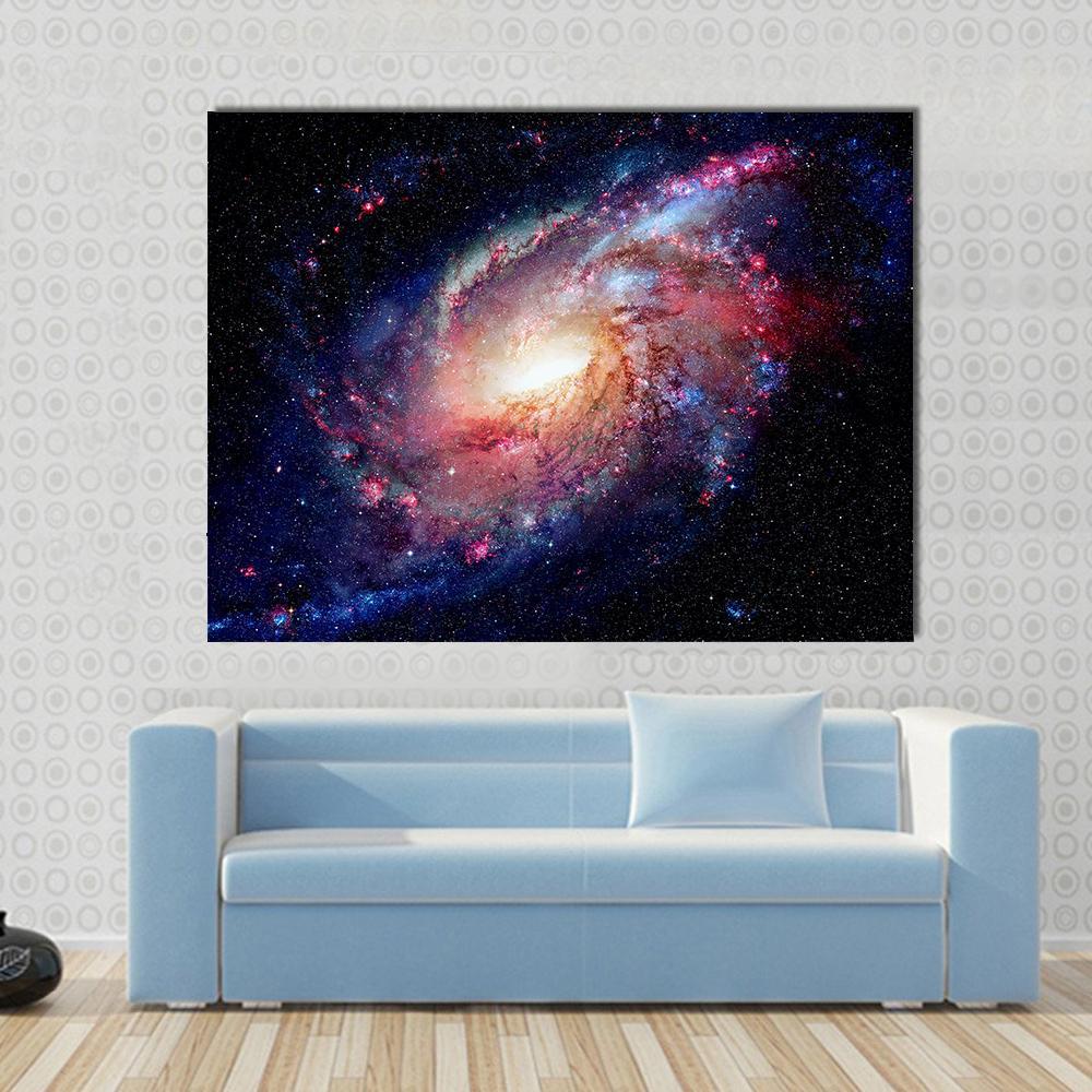 Young Galaxy in Deep Space Canvas Wall Art in black, blue and pink, single panel hung on a wall