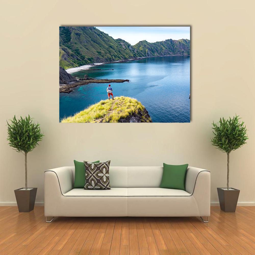 Young Hiker on Coastal Cliff Canvas Wall Art in green and blue, single panel hung on a wall