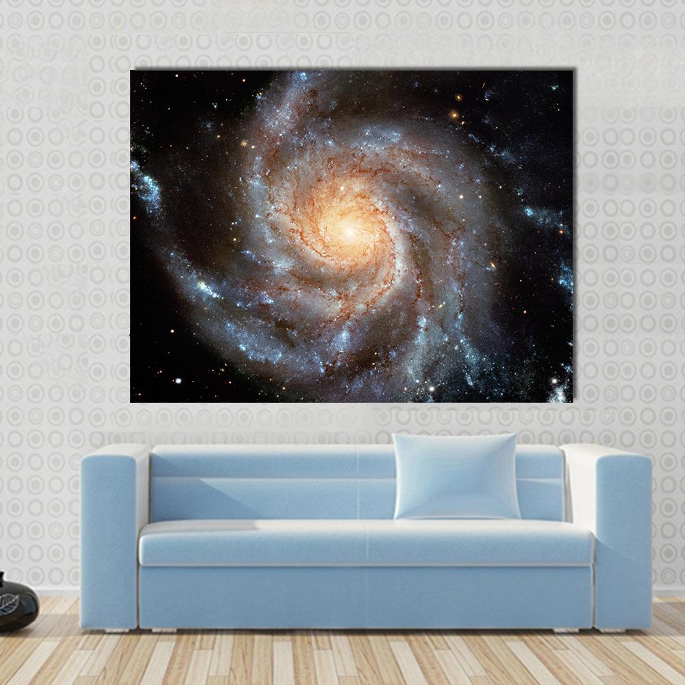 Giant Spiral Disk Canvas Wall Art in black, orange and blue, single panel hung on a wall