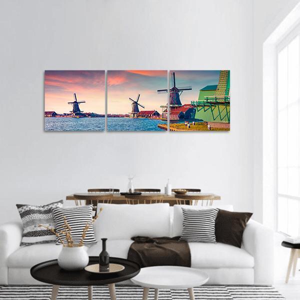 Zaandam Windmills at Sunset Panoramic Canvas Wall Art in orange, blue and pink, hung on a wall
