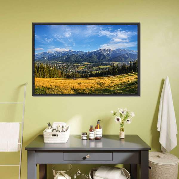 Snow-capped Peaks Above Golden Meadow Canvas Wall Art in yellow, green and blue, framed canvas, product view on a white background