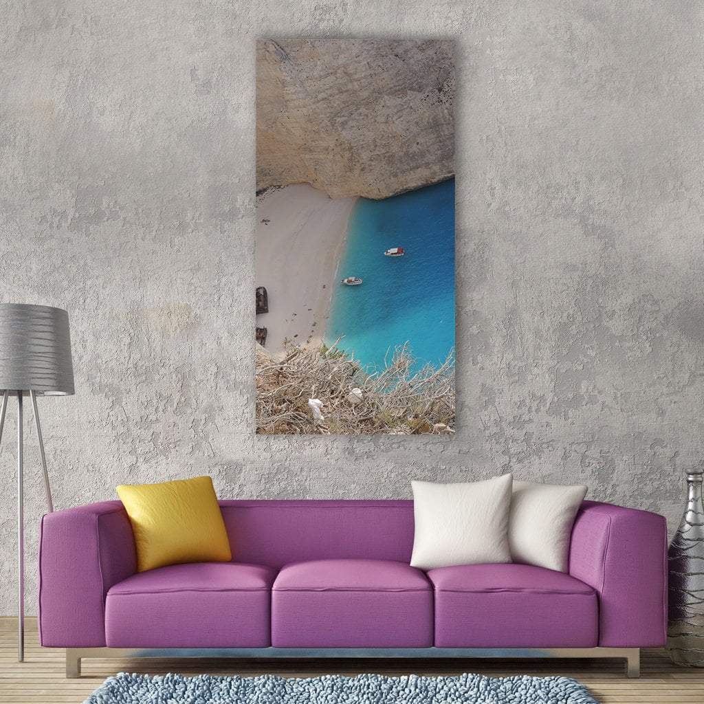 Zante Shipwreck Beach Aerial View Vertical Canvas Wall Art in gray, beige and blue, single vertical panel hung on a wall