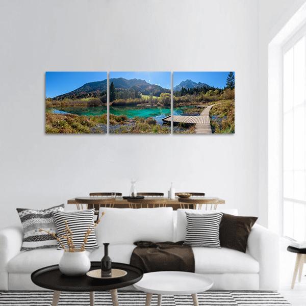 Zelenci Lake, Slovenia Panoramic Canvas Wall Art in brown, green and blue, hung on a wall