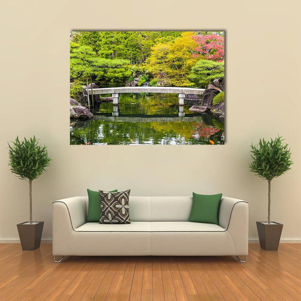 Zen Garden Stone Bridge Over Pond Canvas Wall Art in gray, yellow and green, single panel hung on a wall