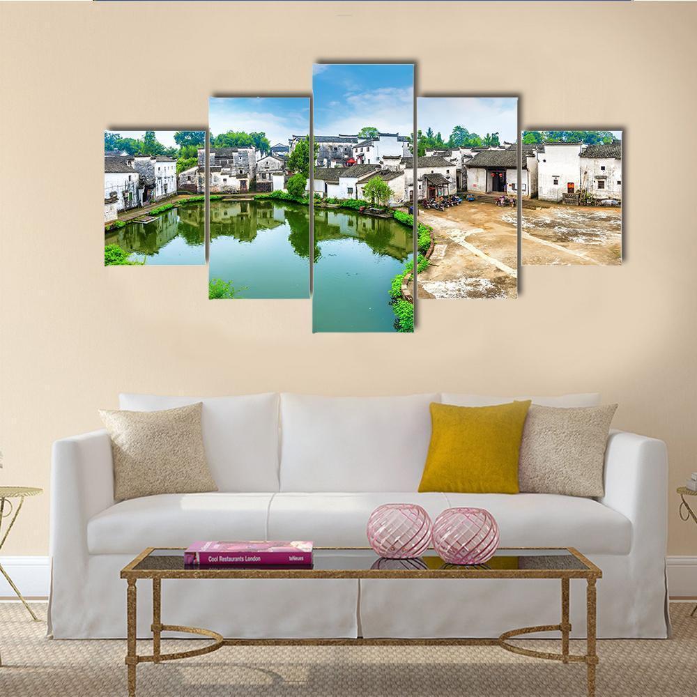 Zhuge Bagua Village Pond Reflection Canvas Wall Art in white, green and blue, 5 panel Star layout hung on a wall