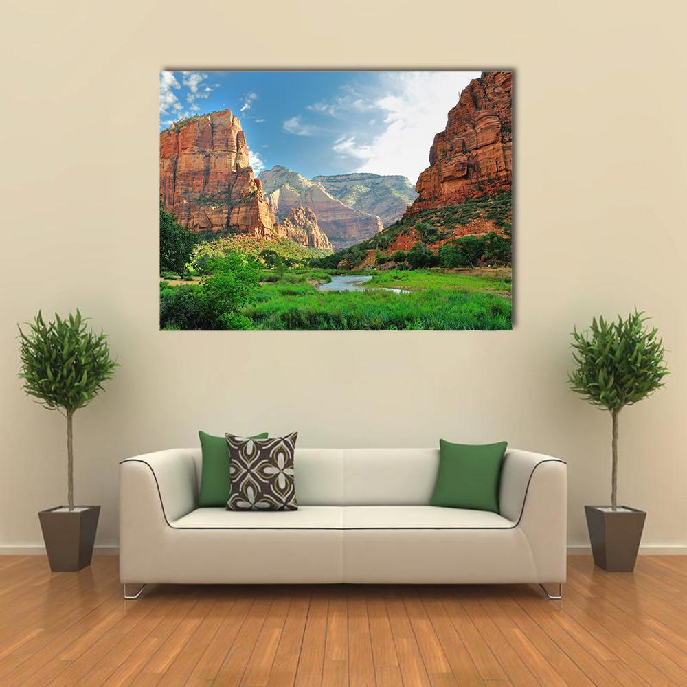 Sunlit Canyon with Winding River Canvas Wall Art in brown, green and blue, single panel hung on a wall