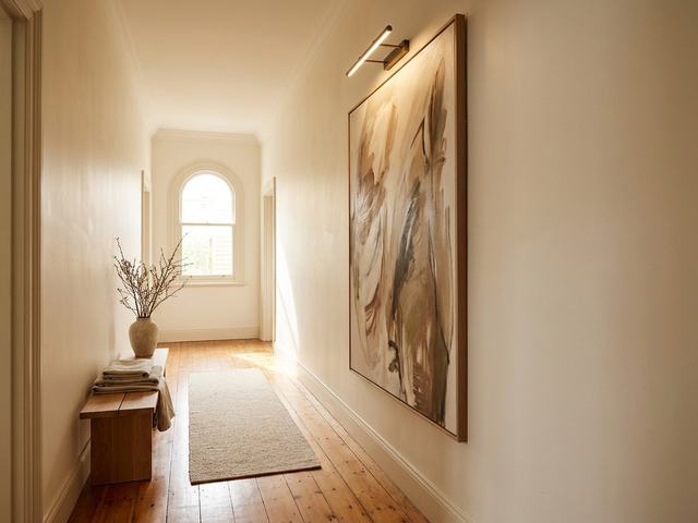 Hallway and Entryway with wall art above the furniture